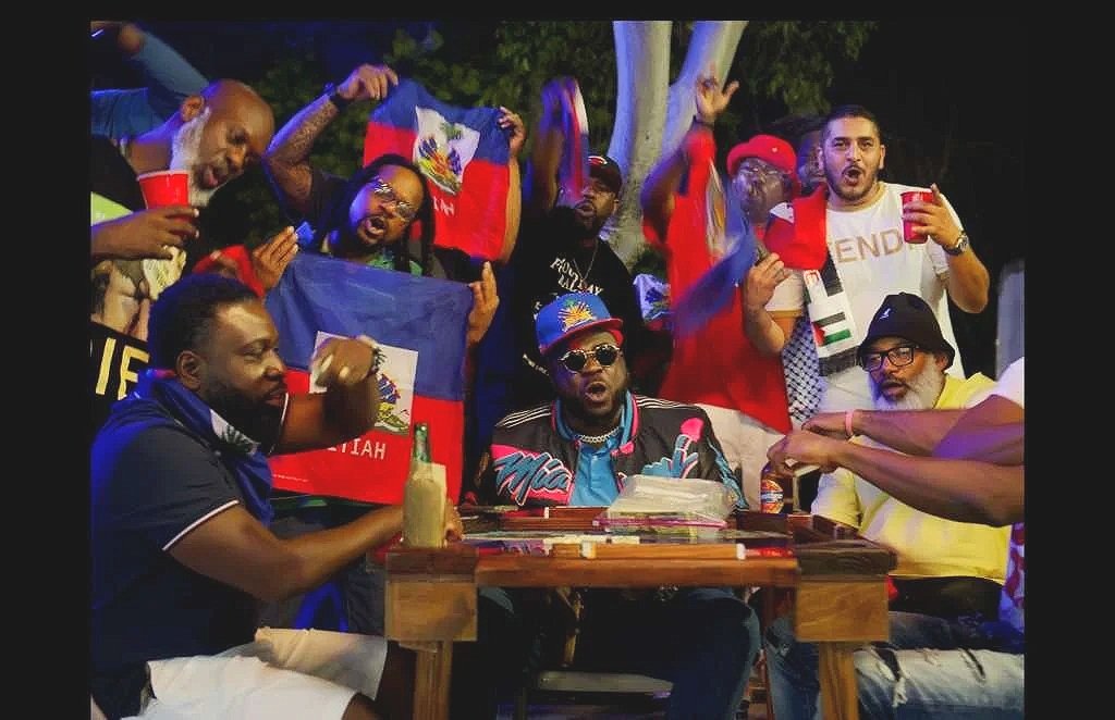 Miami Big Jude with a group gathered around a domino table
